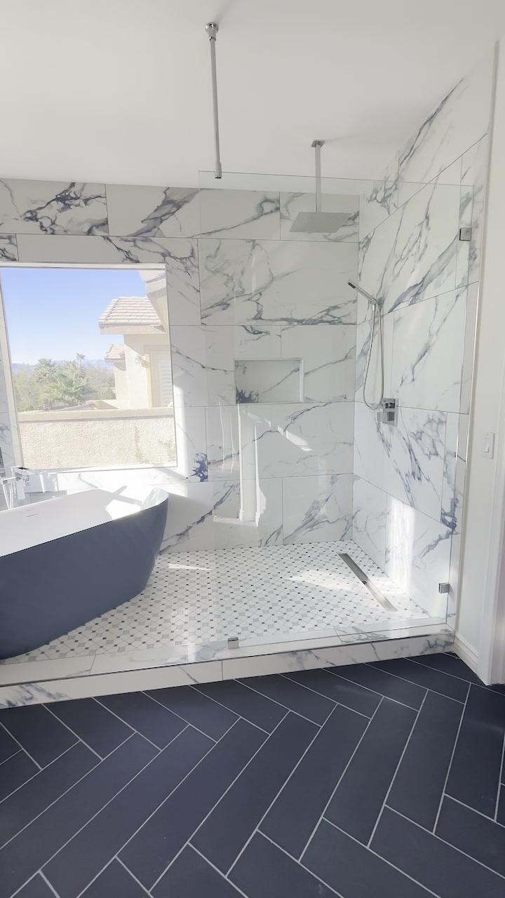 Master bath with marble walk-in shower and freestanding tub