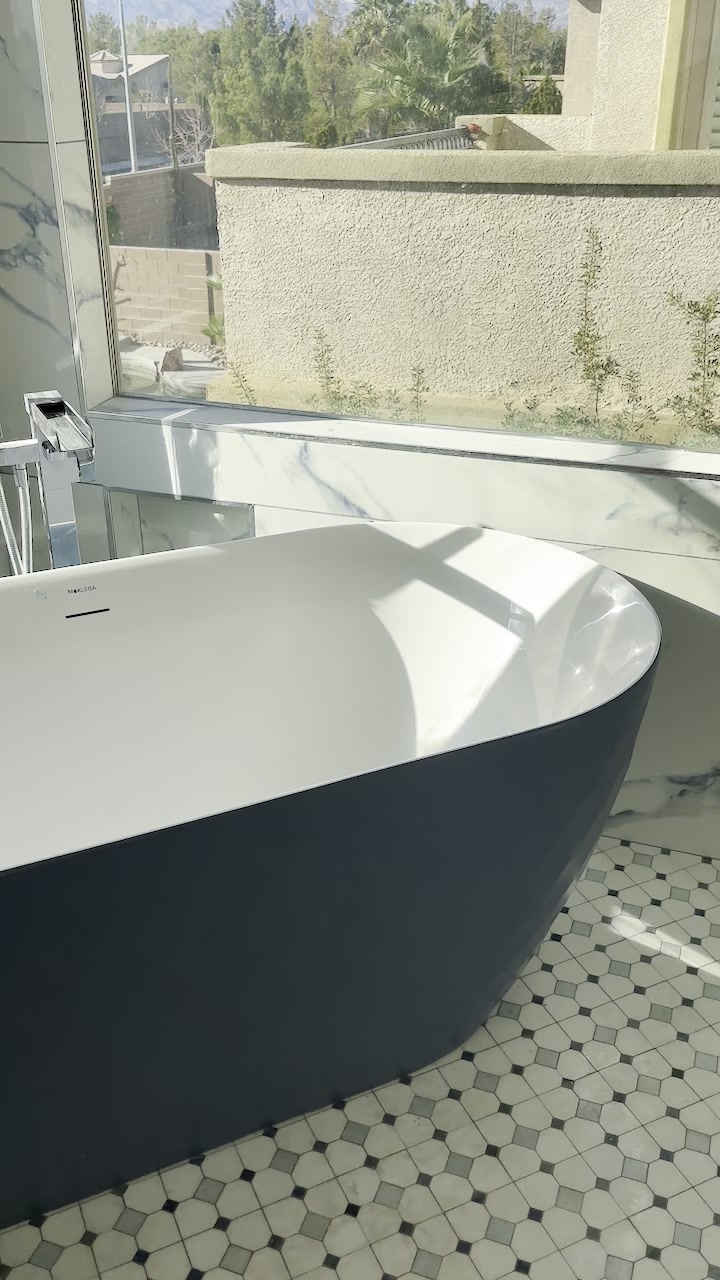 Freestanding tub on custom mosaic tile floor